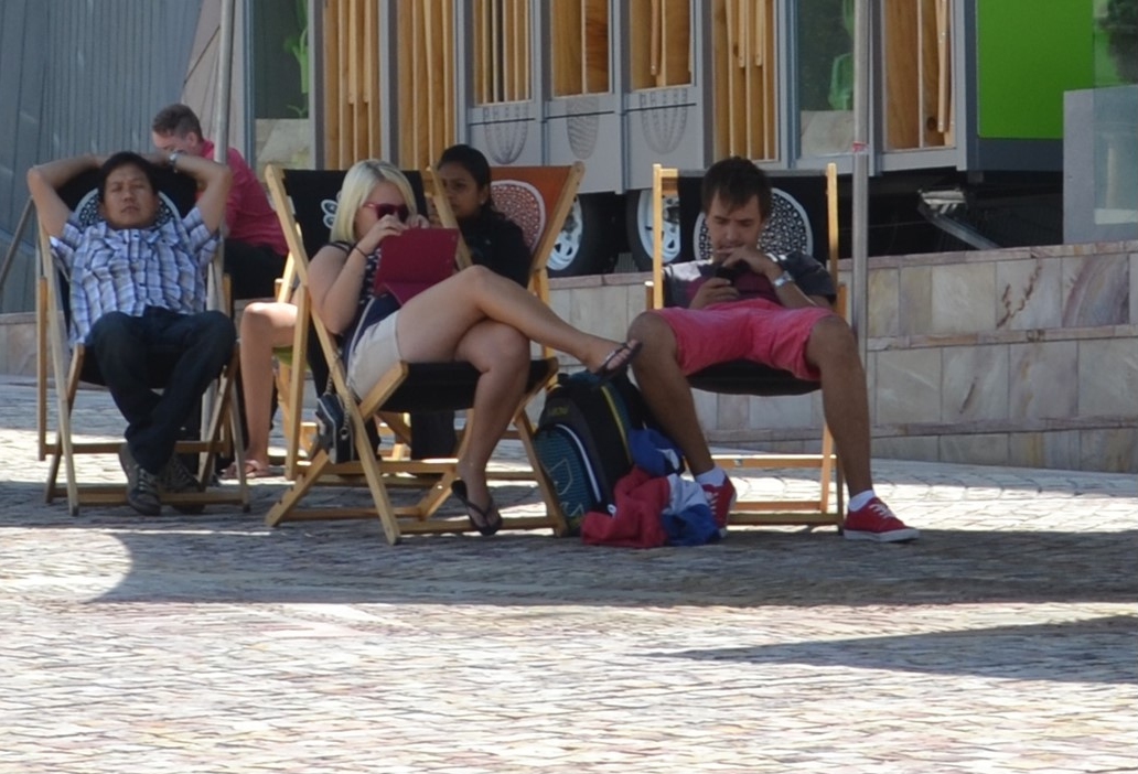  Tablet user sitting in the complimentary beach chairs at Federation Square